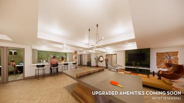 Creekstone at RTP apartment clubhouse with a seating area next to large signage and a wavy carpet over a dark wooden floor